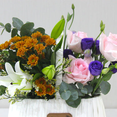 Delicate Pastel Blooms in White Basket – Light Pink Roses & Purple Lisianthus